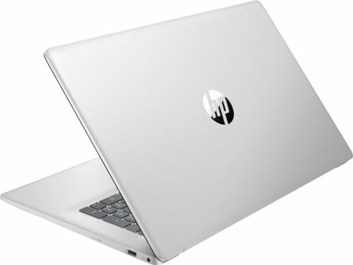 Silver HP laptop partially open, side view.