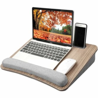 Laptop stand with cushion, laptop, mouse, and phone